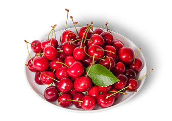 Image showing On top sweet cherries with leaf on white plate