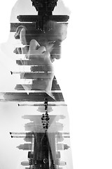 Image showing double exposure of business man with  mobile phone and city buil