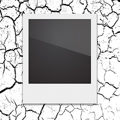 Image showing Retro Polaroid photo frame on the background cracks desert. 