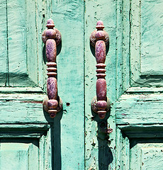 Image showing canarias brass  knocker in a green closed 