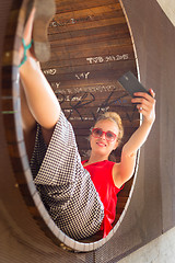 Image showing Young cheerful lady taking selfie.