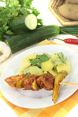 Image showing Potato-cucumber salad with fire skewers of pork