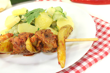 Image showing fresh Potato-cucumber salad with fire skewers
