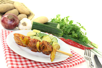 Image showing Potato-cucumber salad with fire skewers and chilli