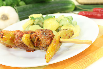 Image showing Potato-cucumber salad with fire skewers