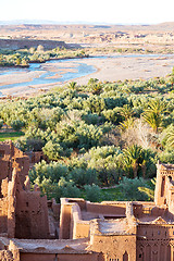 Image showing sunset in africa old construction near       the river blue