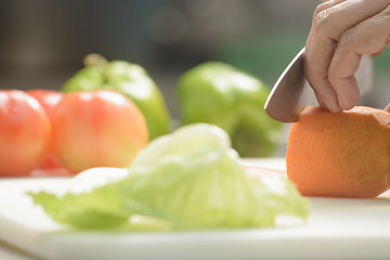 Image showing Female Cook Cutting Carrot