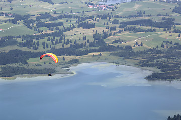 Image showing Paraglider flying over Bavarian lake