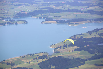 Image showing Paraglider flying over Bavarian lake