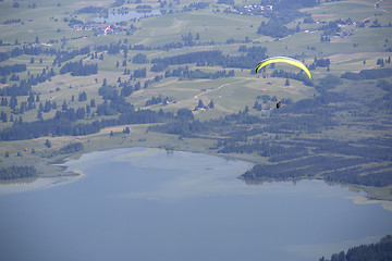 Image showing  Paraglider flying over Bavarian lake