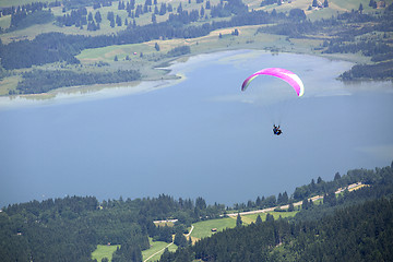 Image showing Paraglider flying over Bavarian lake