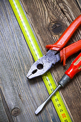 Image showing vintage pliers, old screwdriver and measuring tape