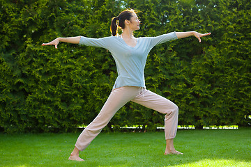 Image showing adult pretty woman doing yoga exercises