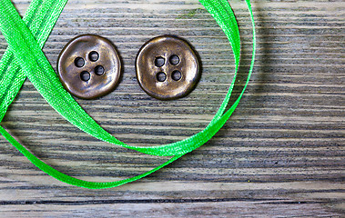 Image showing still life with old green tape and two vintage buttons