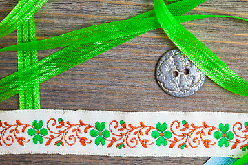 Image showing vintage embroidered band and tape with old classic button