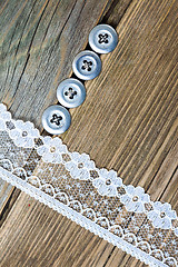 Image showing four vintage buttons and lace tape