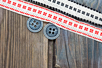 Image showing vintage ribbons with embroidered ornaments and old button