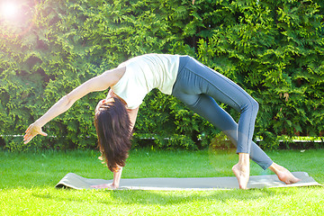 Image showing pretty adult woman doing yoga at summer morning