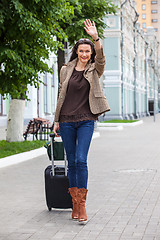 Image showing pretty adult woman traveler with suitcase