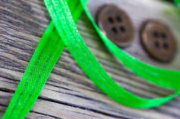 Image showing still life with old green tape and two vintage buttons