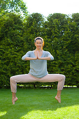 Image showing adult woman doing yoga exercises in the park