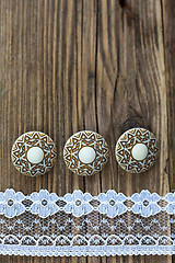 Image showing three vintage button and lace tape