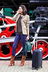 Image showing beautiful adult woman traveler on the platform near the old stea