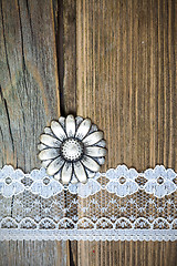 Image showing vintage metal button and lace tape