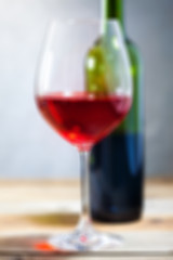 Image showing red wine in glass and green bottle