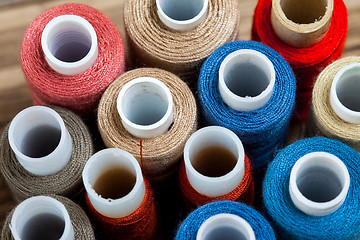 Image showing several varicolored spools of thread 
