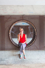 Image showing Young cheerful woman talking on cellphone.