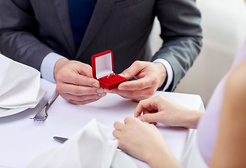 Image showing excited young woman and boyfriend giving her ring