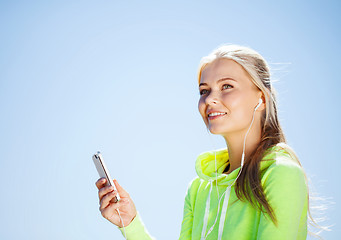 Image showing woman listening to music outdoors