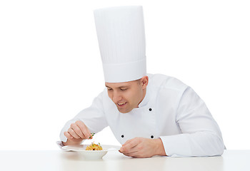 Image showing happy male chef cook decorating dish