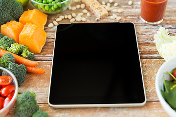Image showing close up of blank tablet pc screen and vegetables