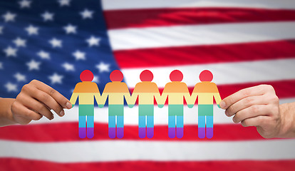Image showing hands holding rainbow people over american flag
