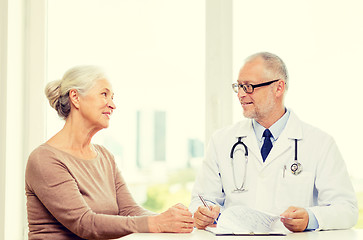 Image showing smiling senior woman and doctor meeting