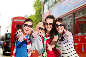 Image showing happy teenage girls or women showing thumbs up