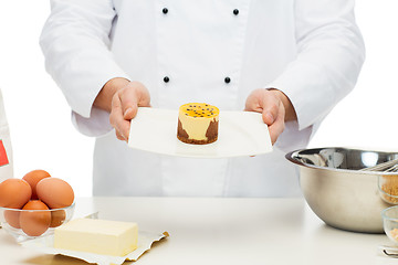 Image showing close up of male chef cook baking dessert