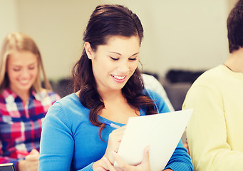 Image showing group of smiling students with notebook