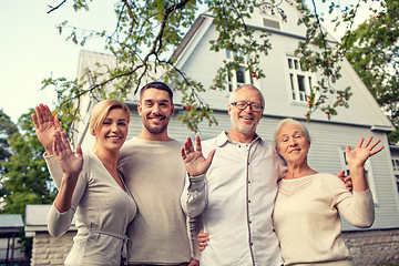 Image showing happy family in front of house outdoors