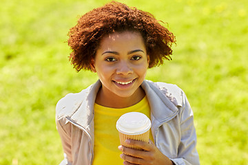 Image showing smiling african woman drinking coffee outdoors 