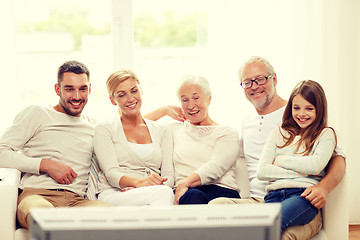 Image showing happy family watching tv at home