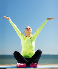 Image showing woman doing yoga outdoors