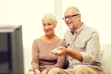 Image showing happy senior couple watching tv at home