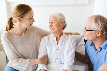 Image showing happy family visiting senior woman at hospital