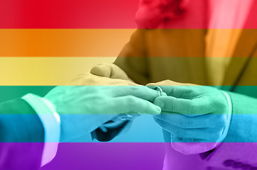 Image showing close up of male gay couple hands and wedding ring