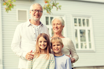 Image showing happy family in front of house outdoors