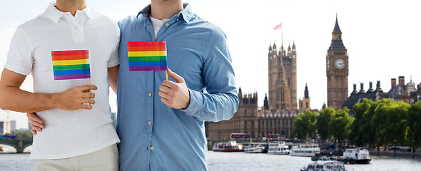 Image showing close up of male gay couple with rainbow flags