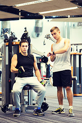 Image showing men exercising on gym machine